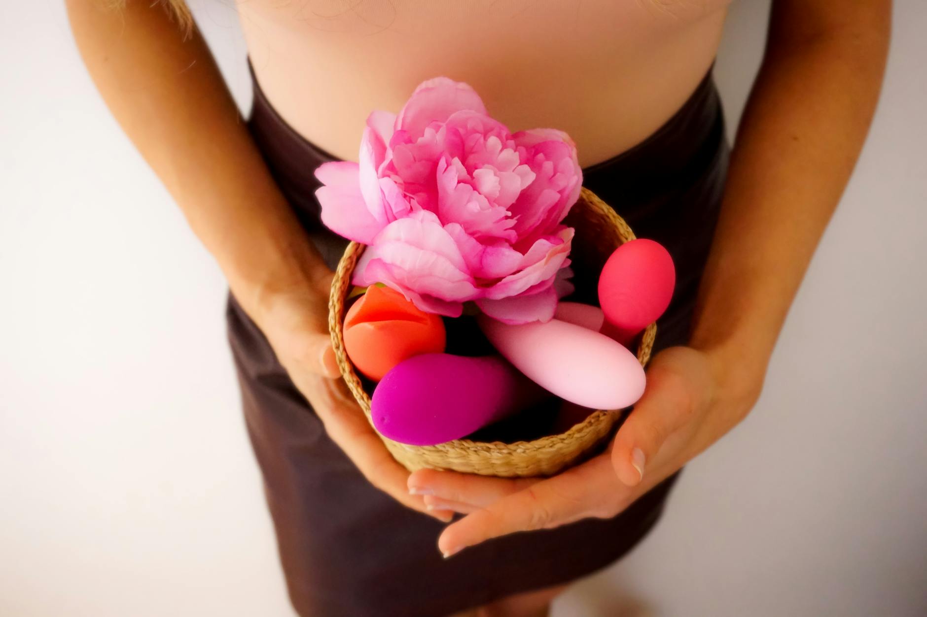 Vibrant collection of clitoral vibrators arranged on a bright yellow surface, showcasing diverse design and color.